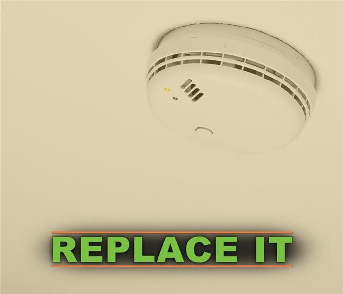 Smoke alarm with the words REPLACE IT 